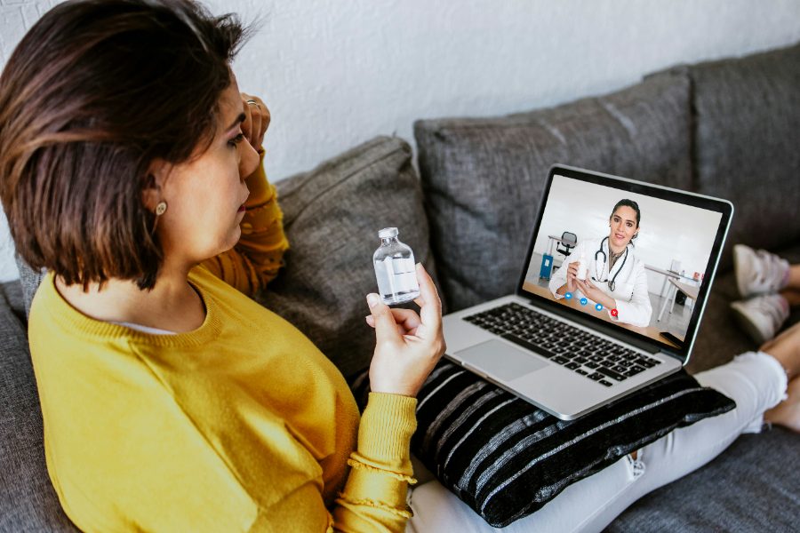 Patient on a video visit with a clinician from her couch